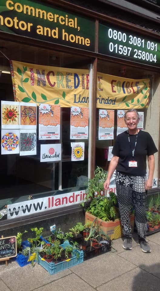 Dorienne outside the Coversure shop on Middleton Street, with some of the plants the group gave away