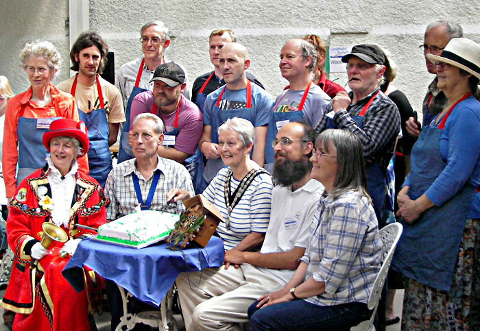 Cutting the anniversary cake at the Llandrindod Repair Cafe first anniversary